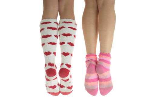 Four legs with colorful socks (isolated on white)