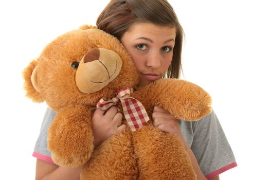 Beautiful teenager holding a teddy bear - isolated on white background