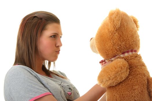 Beautiful teenager holding a teddy bear - isolated on white background