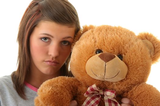 Beautiful teenager holding a teddy bear - isolated on white background