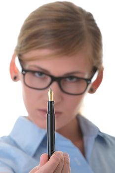 Portrait of a thoughtful young woman in blue shirt holding pen (secretary, student or young businesswoman)