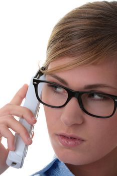 Portrait of a thoughtful young woman in blue shirt and glasses with phone