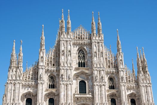 Gothic facade of Milan Cathedral in Piazza del Duomo. It is the fourth largest church in the world. The construction started in 1386 and took about five centuries.