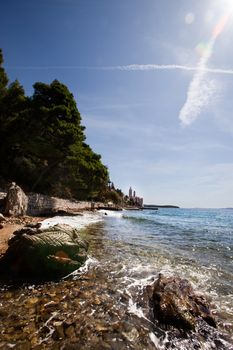 The coast of croatia on the Island of Rab with the old city in the background