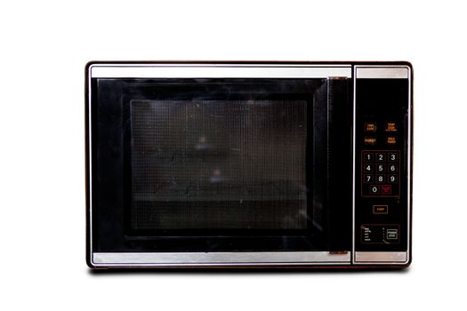 An old microwave isolated on white