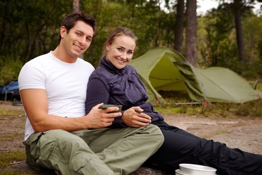 An couple enjoying the outdoors while camping.