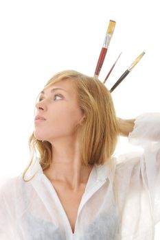 A female blond artist in white uniform with brushes - painting