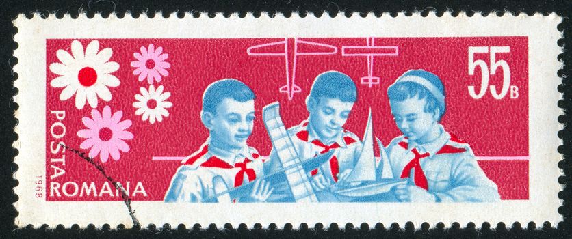 ROMANIA - CIRCA 1968: stamp printed by Romania, shows pioneer building model of plane and boat, circa 1968