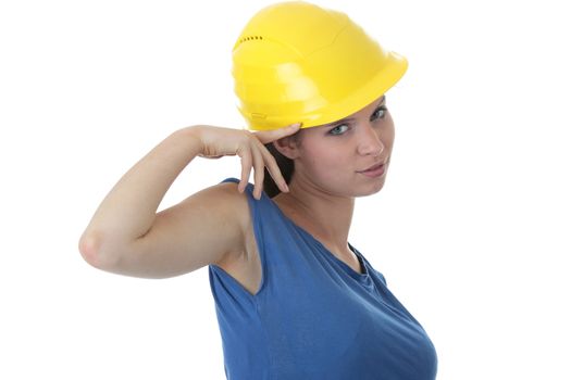 Young female architect or builder wearing a yellow hart hat on a construction site