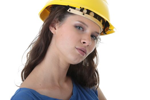 Young female architect or builder wearing a yellow hart hat on a construction site