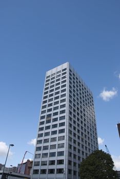 A Grey Coloured Apartment Block under a blue sky