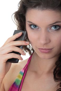 Beautiful Young Woman Wearing A Colorful Bikini Top Using A Mobile Cellphone Isolated Over White