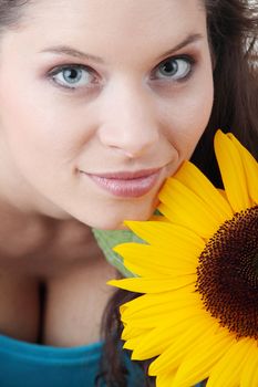 Portrait of a Beautiful girl with sunflower, studio shot over white