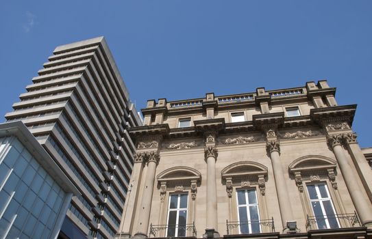 A Skyscraper and a vintage stone building in an english city