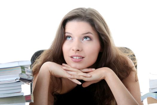 Portrait of young and pretty female student with books around isolated on white background