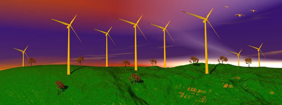 Birds flying upon wind turbines on a green hill with trees and colorful sky