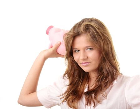 Young beautiful woman siting at the desk with piggy bank (money box), isolated on white background