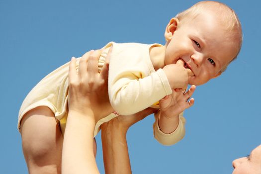 Mother with baby under blue clear sky