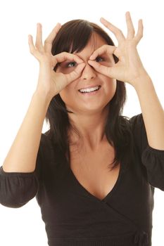 Young casual woman looking through fingers (hands) isolated on white