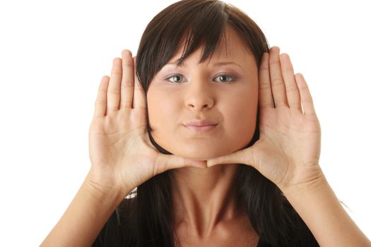 Young woman, framing her face with her hands