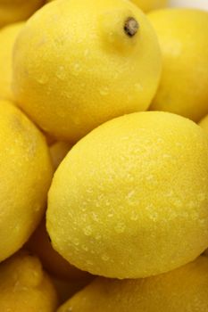 closeup of a pile of fresh lemon with water drops