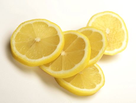 slices of fresh lemon on white background