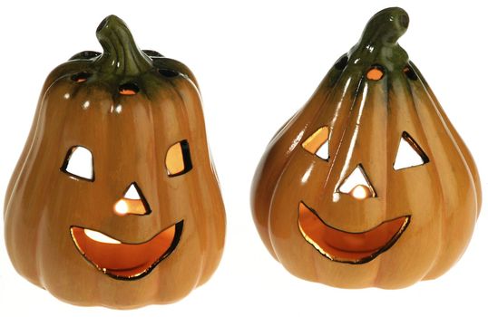 two ceramic pumpkins with a light candle inside