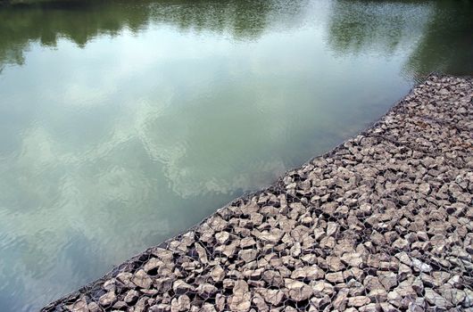 Metal cages with stone inside, used for building and shoring up of an embankment for example a motorway or for forming a sea defence or the like.