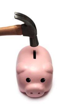 A cute piggy bank isolated on a white background, about to be broken by a hammer.