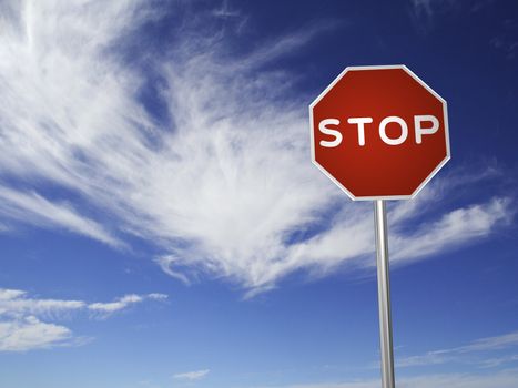 A red, traffic, STOP sign, made on a 3D rendering software.

(with a sky background)