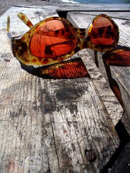 Sunglasses on wooden table
