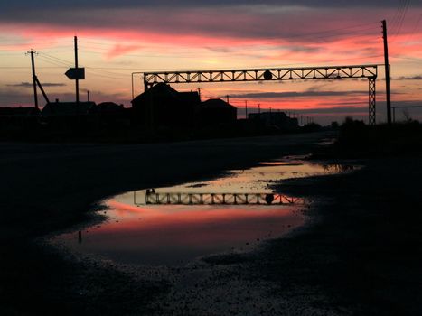 The Reflection evening sky in puddle after rain