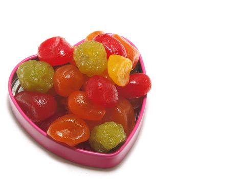 Greeting card at date of Valentine's Day. A pink box with the candied fruits