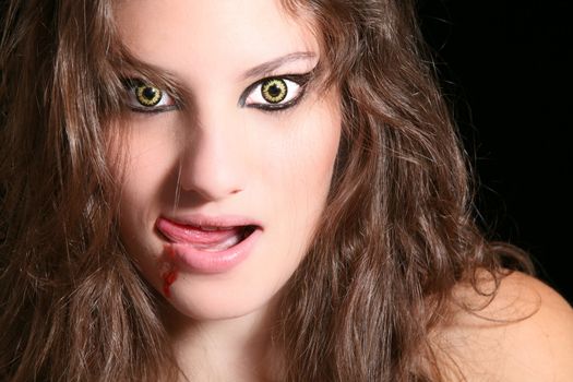 Scary woman with wolf eyes licking her lips