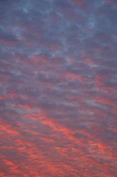 mackerel clouds with shades of red, orange and blue at sundown
