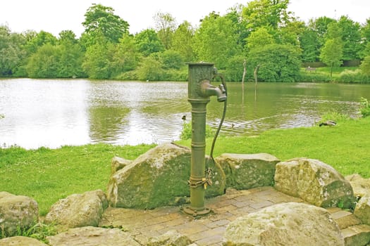 view of a village water pump on the village green