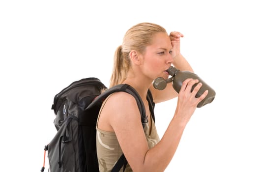 Beautiful blond girl wiping the sweat of her forehead while taking a sip of water