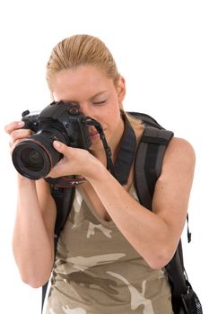 Young blond woman with big camera around her neck taking pictures