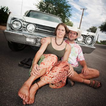 Happy Adult Couple with Vintage White Car