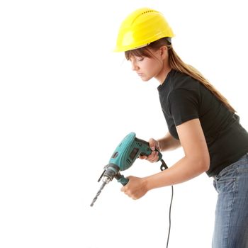 Young woman builder in yellow helmet holding driller