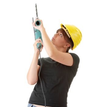 Young woman builder in yellow helmet holding driller