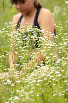 A young woman doing yoga outside in natural environment