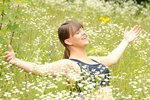 A young woman doing yoga outside in natural environment