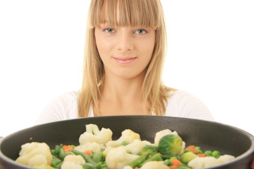 Image of a young woman cooking healthy food in the kitchen