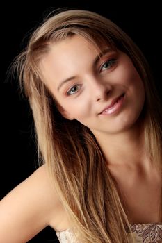 Young beautiful woman in gold dress portrait isolated on black background
