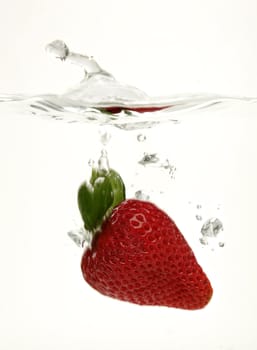 fresh strawberry splashing into water