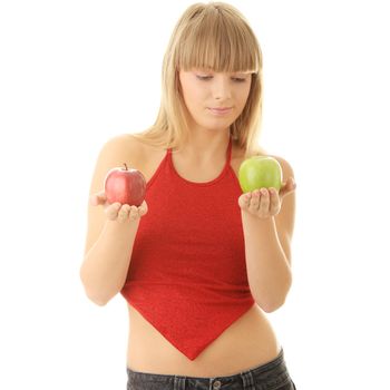 Young blond woman with red and green apples on her hand - making decision concept