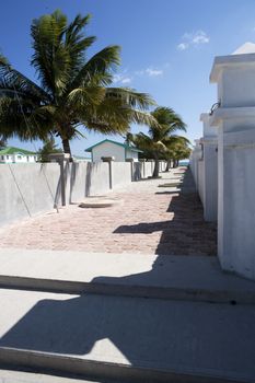 A walled and tile walkway leads to a beautiful beach in the Gulf of Mexico.