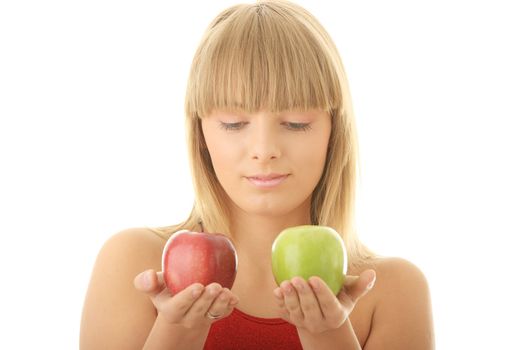 Young blond woman with red and green apples on her hand - making decision concept