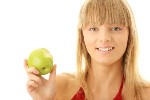 Young blond woman with green apple isolated on white background - healthy concept